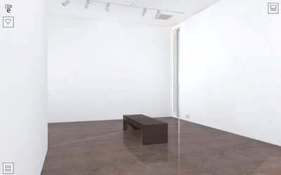 The gallery has a chocolate tinted, low sheen, stone floor and a simple wooden bench that imparts scale with a minimum of fuss.