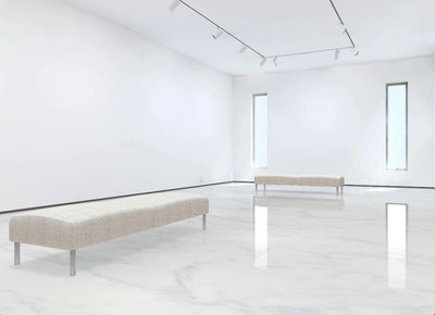 This medium sized gallery has a clean modern décor with a white marble floor. The walls are washed with a combination of spots and natural light from the three windows.